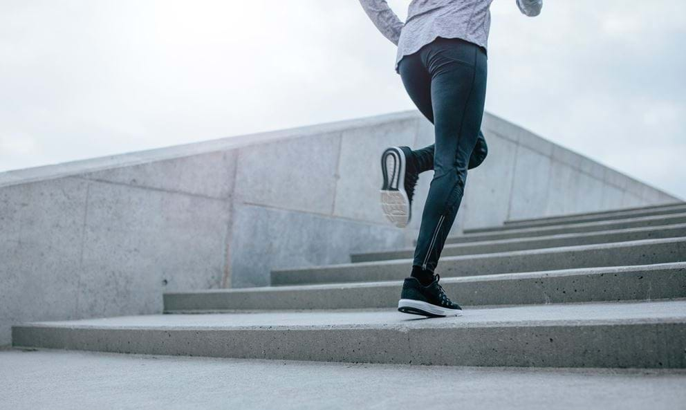 Running up gray concrete stairs