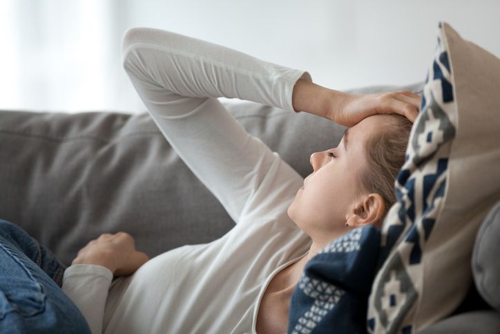 Woman resting, showing signs of migraine