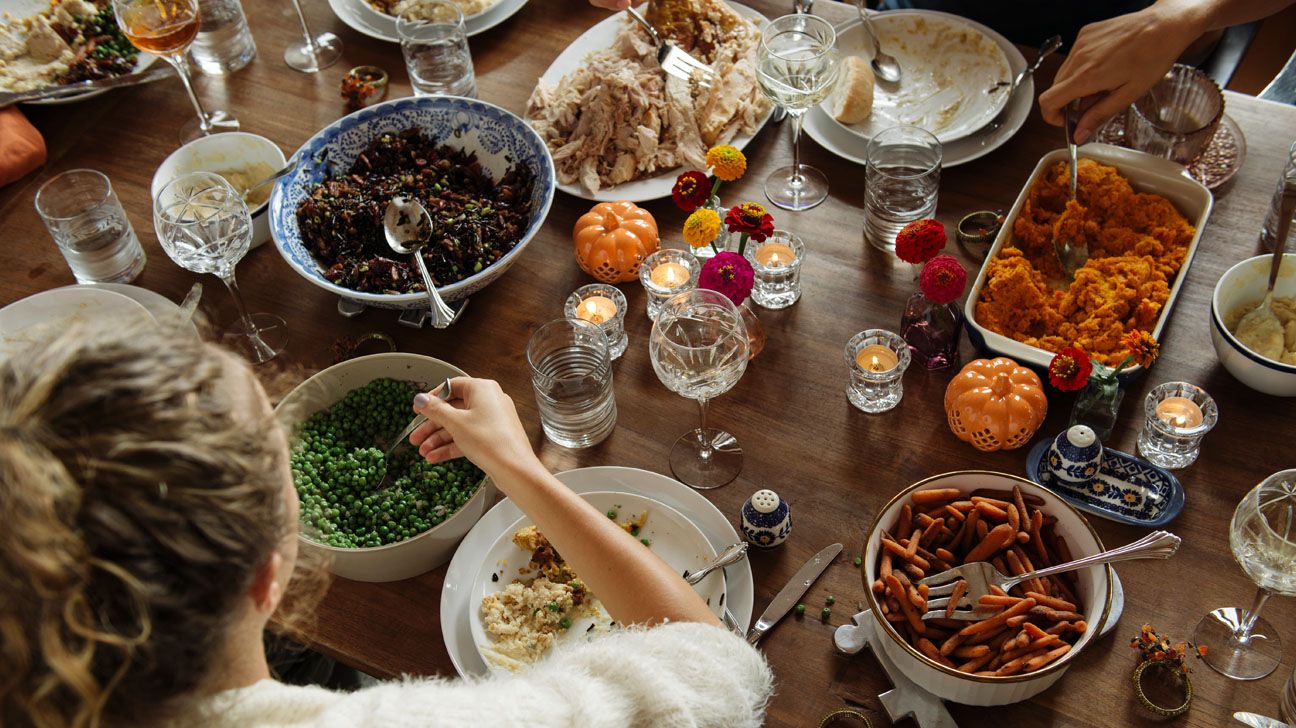 Woman eating Thanksgiving dinner at table