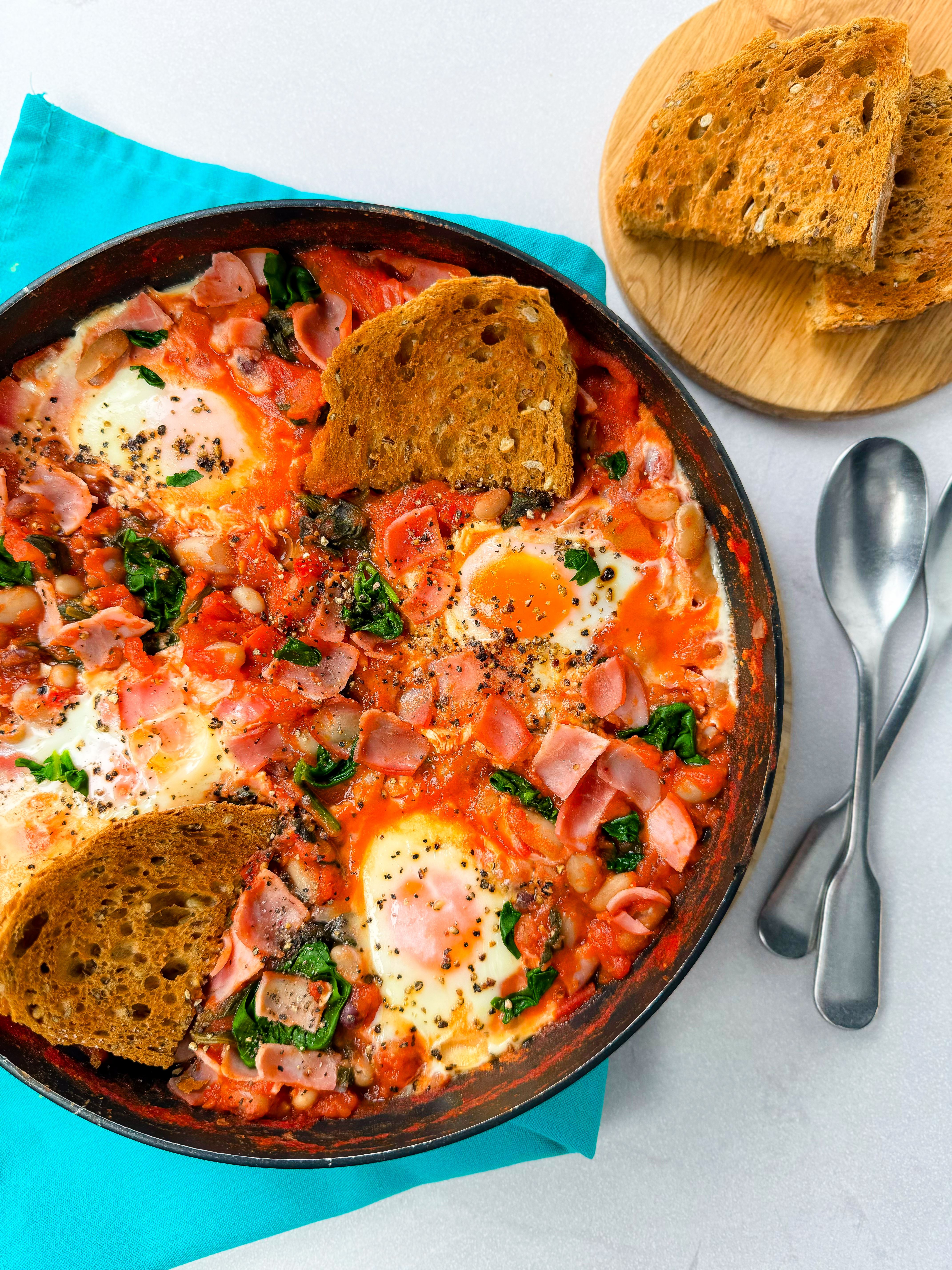 Bean and baked eggs in skillet