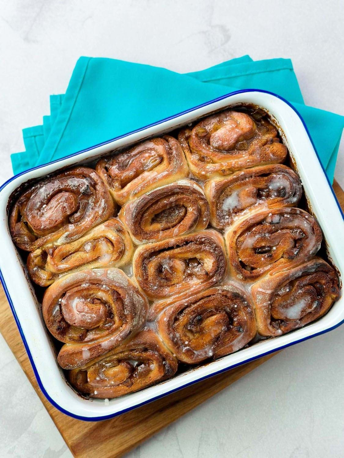 Glazed cinnamon rolls in baking pan