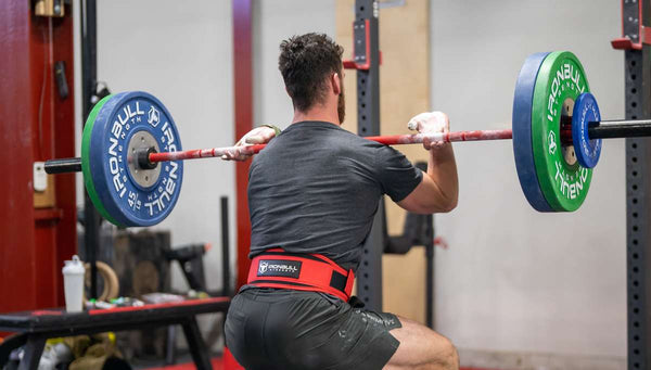 Man lifting barbell in gym