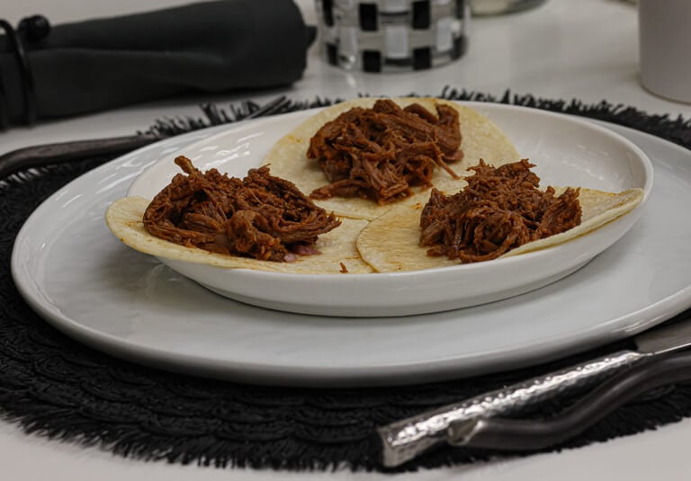 Three beef tacos on plate