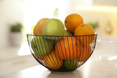 Red apples and oranges in basket