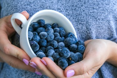 Blueberries in white ceramic mug