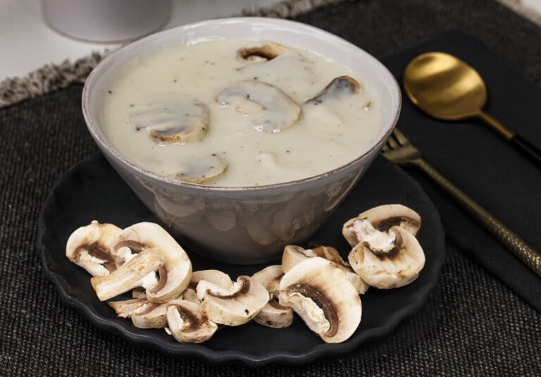 Creamy mushroom sauce in white bowl