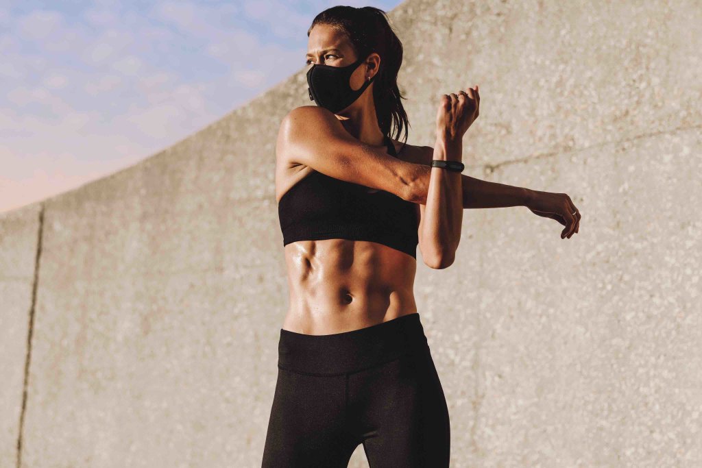 Woman exercising with mask outdoors