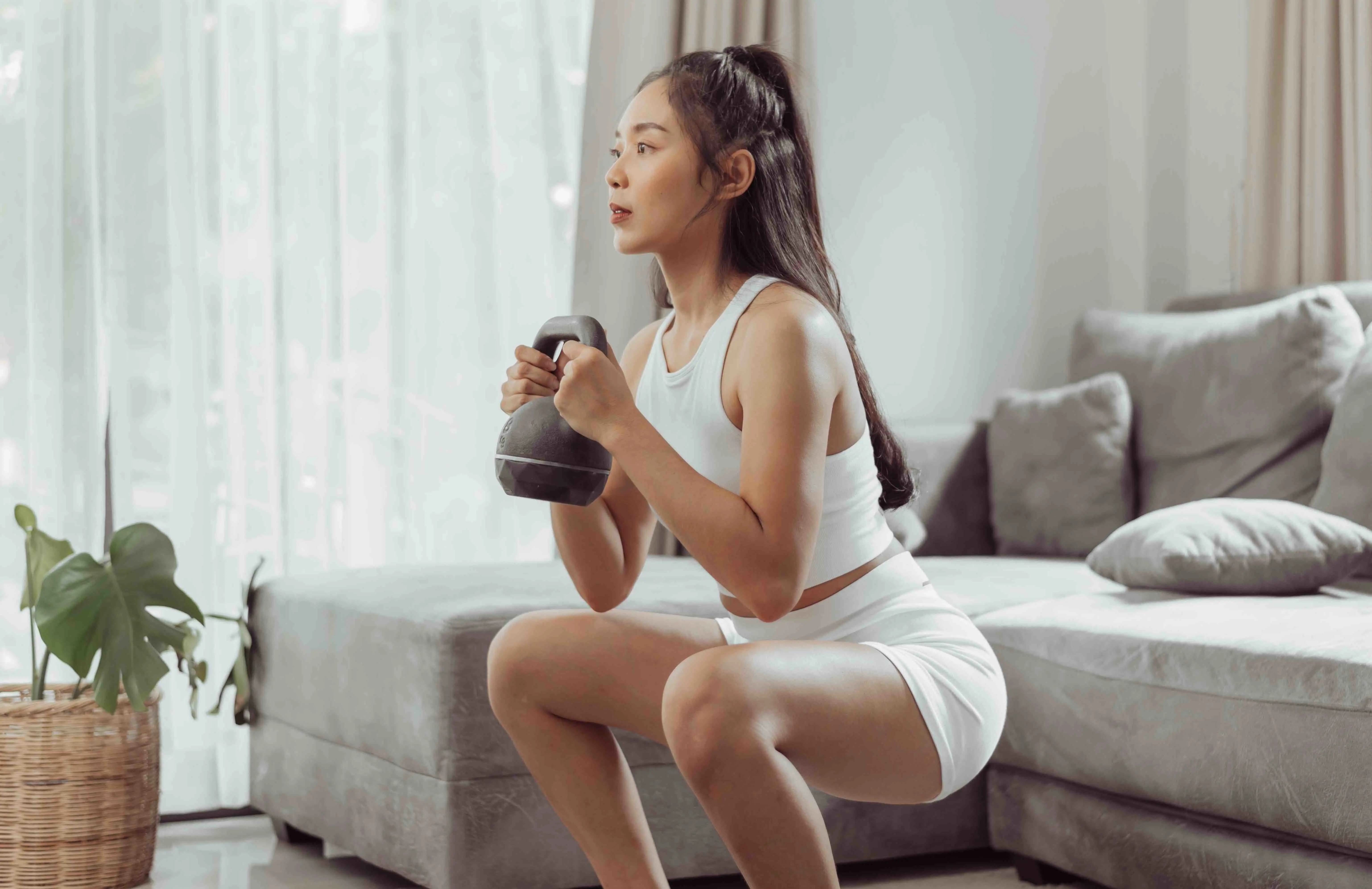 Woman doing kettlebell workout at home