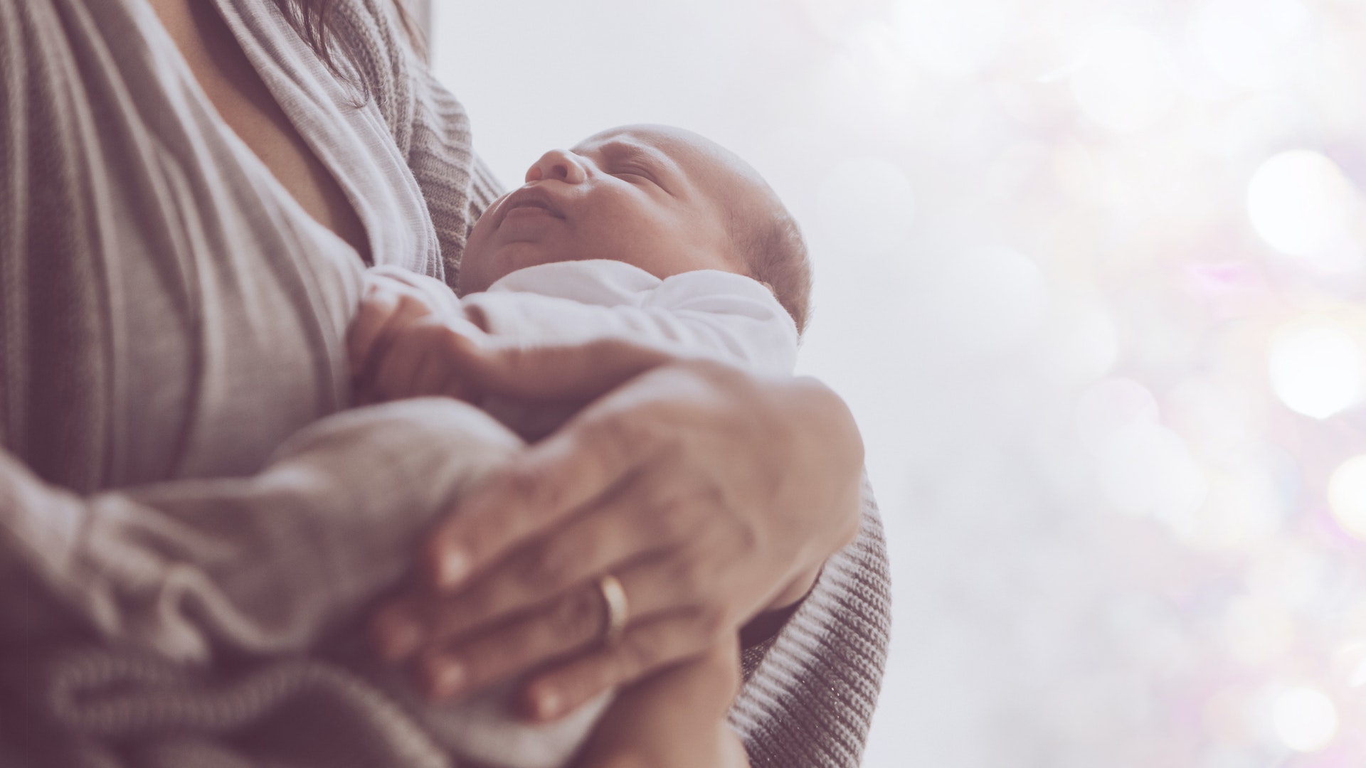 Woman cradling sleeping baby