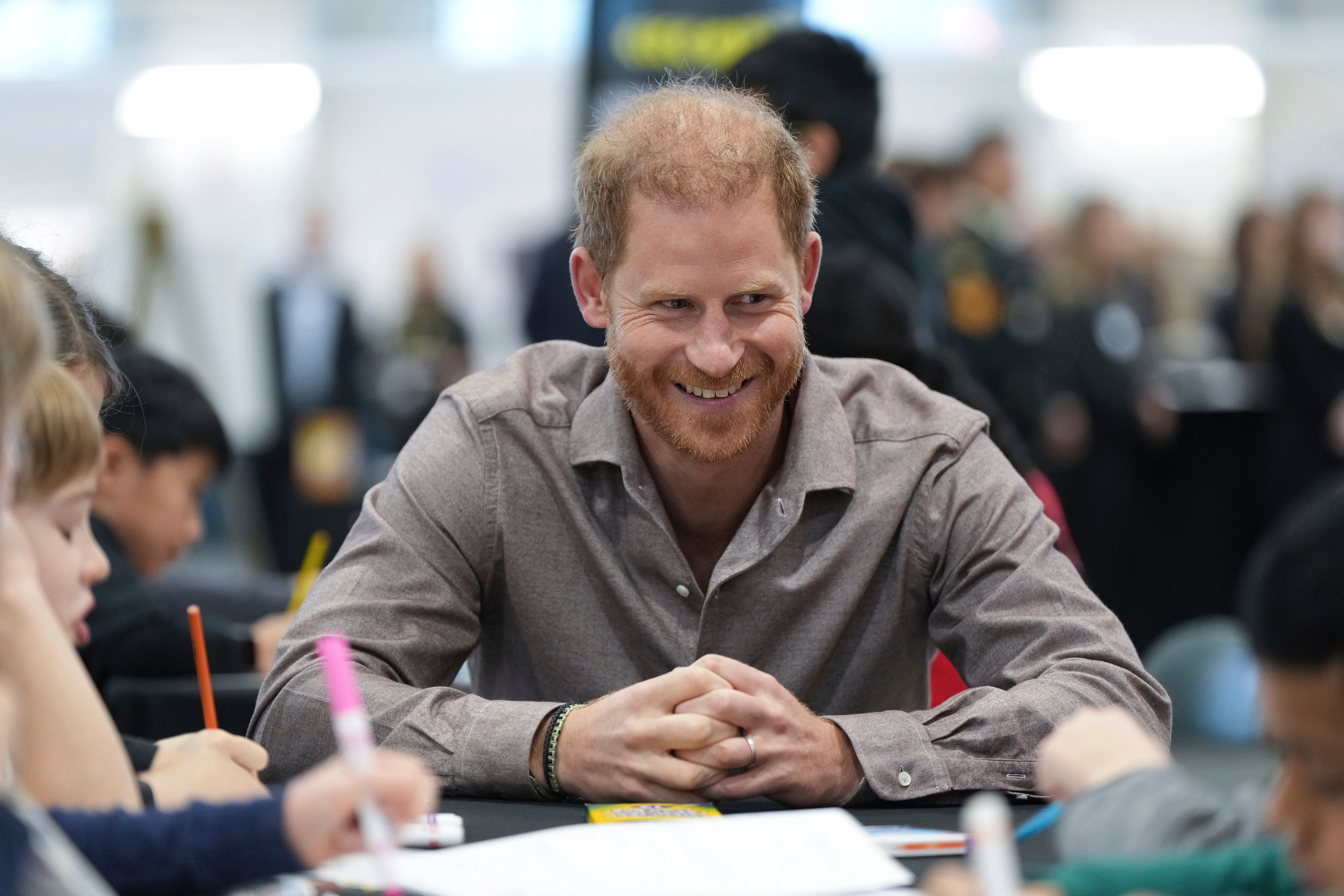 Prince Harry smiling in classroom setting