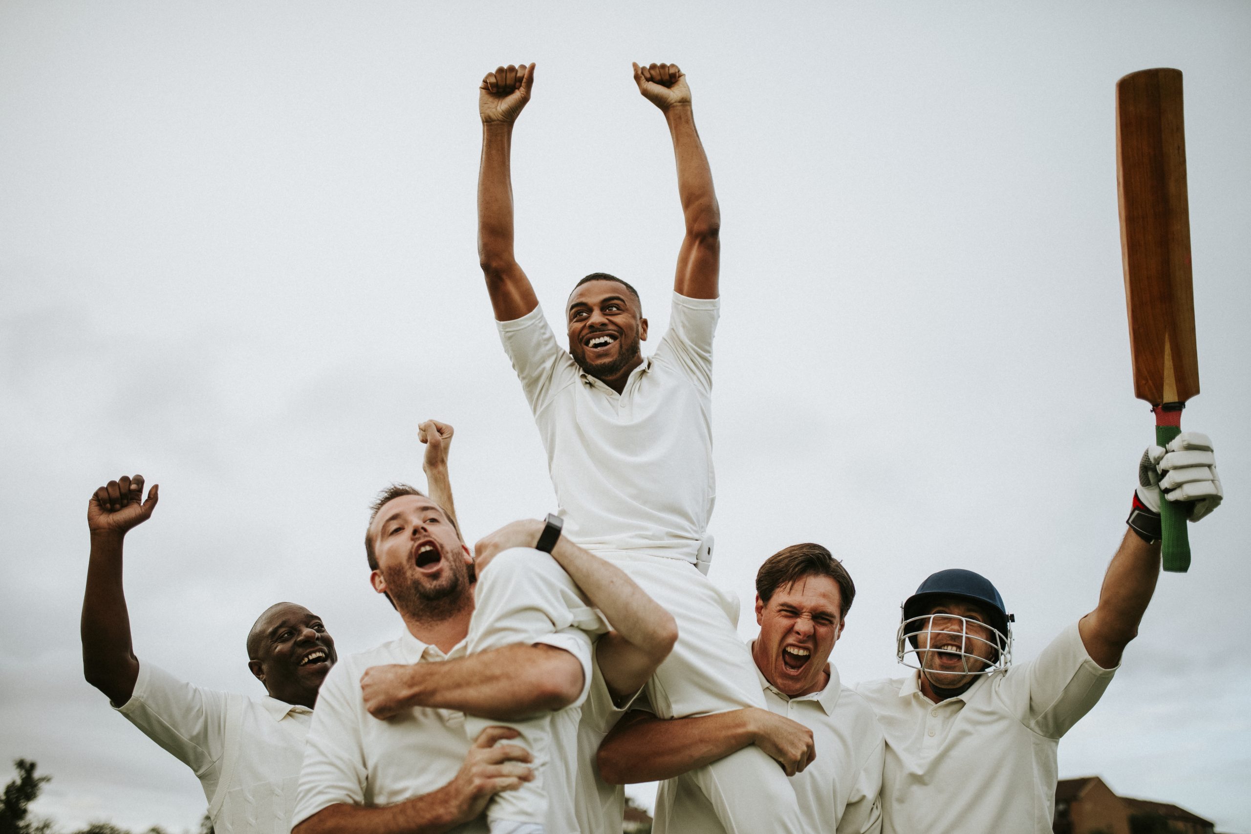 Men celebrating victory with raised arms