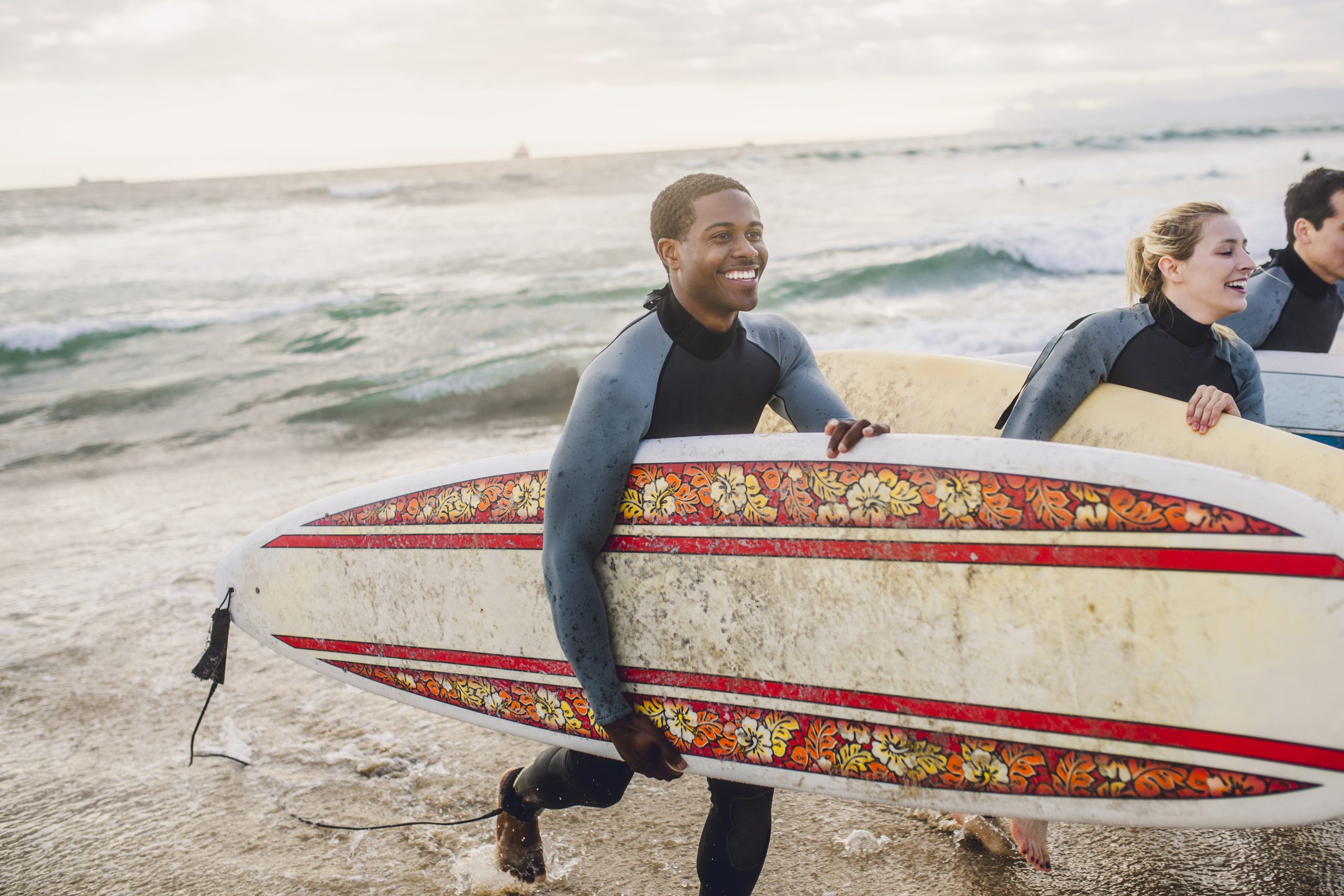 Two surfers with boards on beach