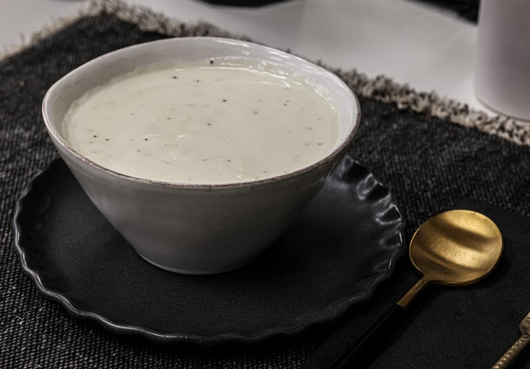 Creamy alfredo sauce in white bowl