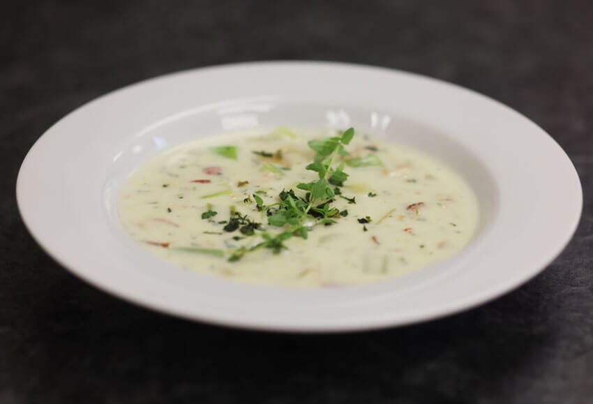 Creamy clam chowder, garnished