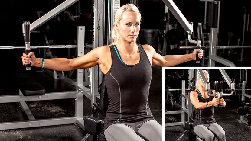 Woman performs fly exercise on machine