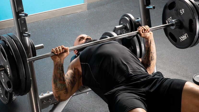 Man performing chest workout with dumbbells