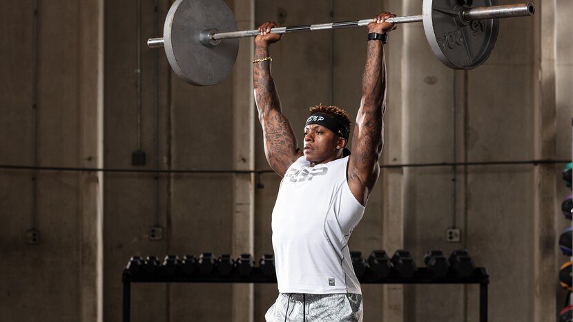 Man performing barbell push press