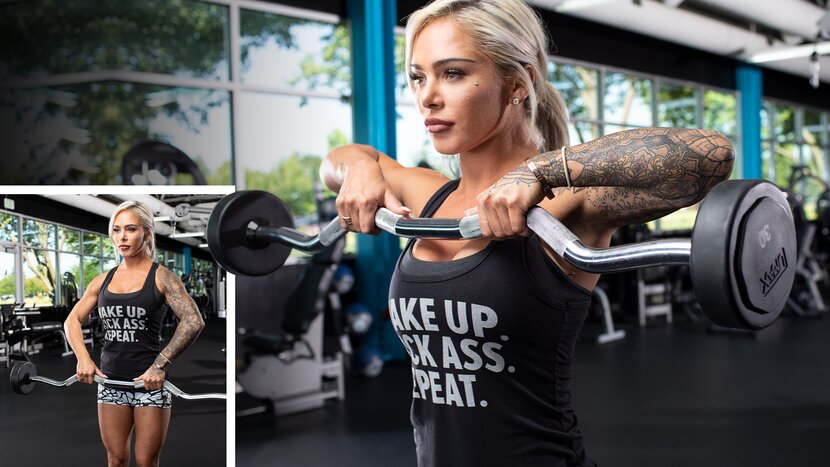 Woman performing upright row with barbell