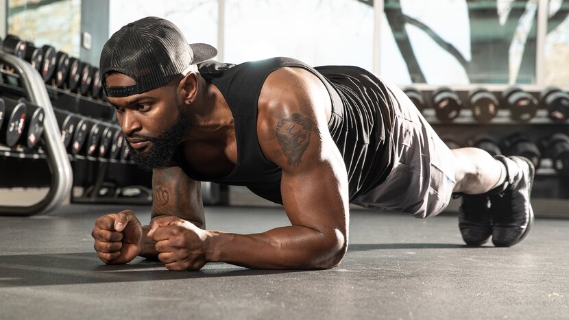 Man performing plank on floor