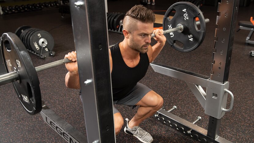 Man doing barbell back squat