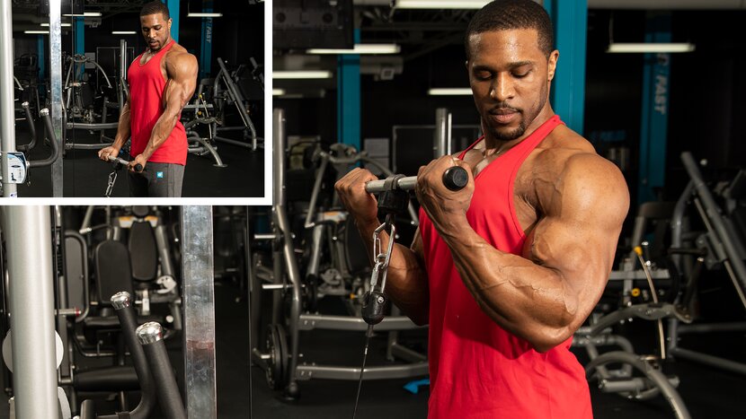 Man performs standing cable bicep curl