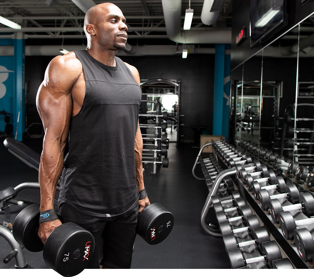 Man performing back workout with dumbbells