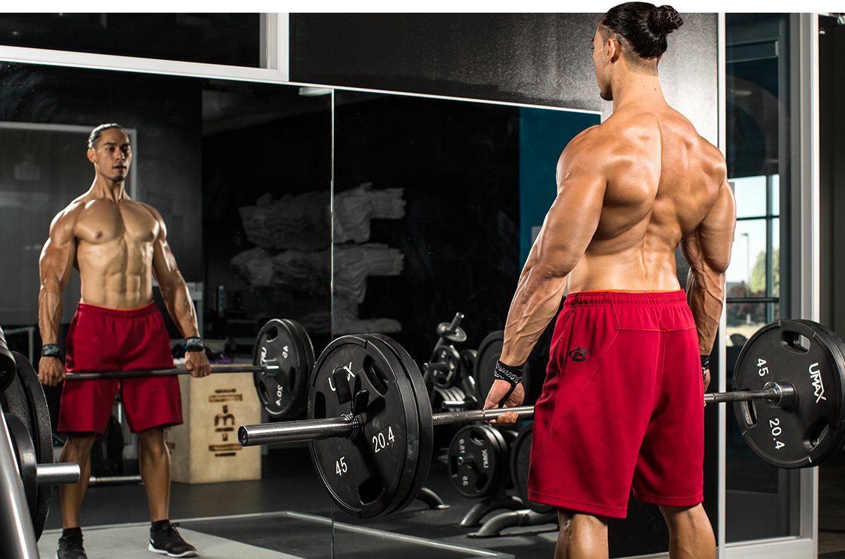 Shirtless man performing back workout