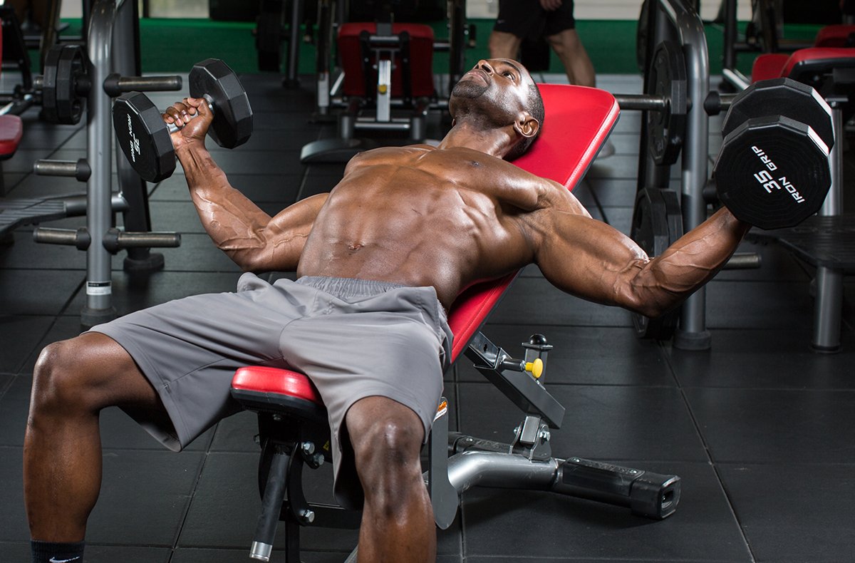 Man performing dumbbell chest press