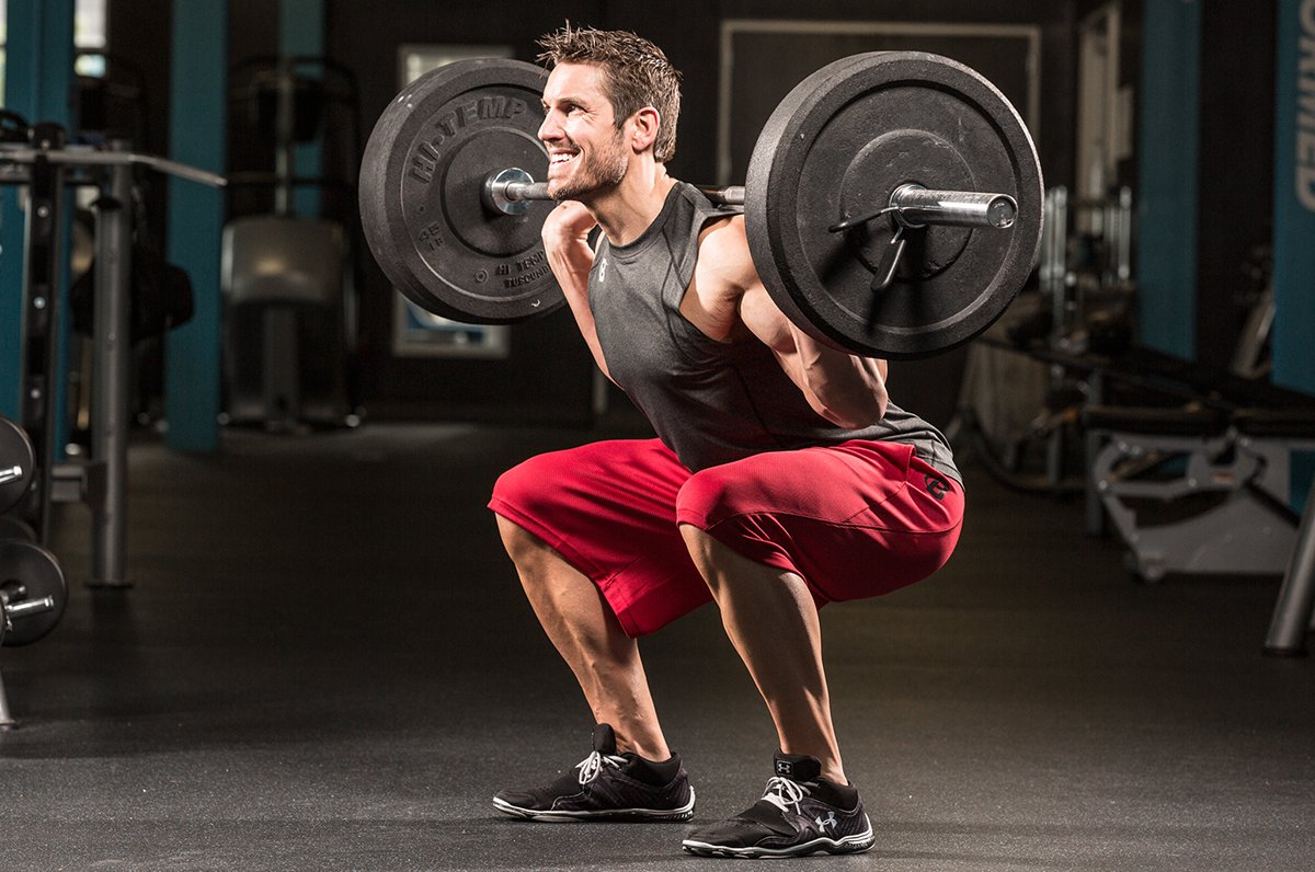 Man performing barbell squats