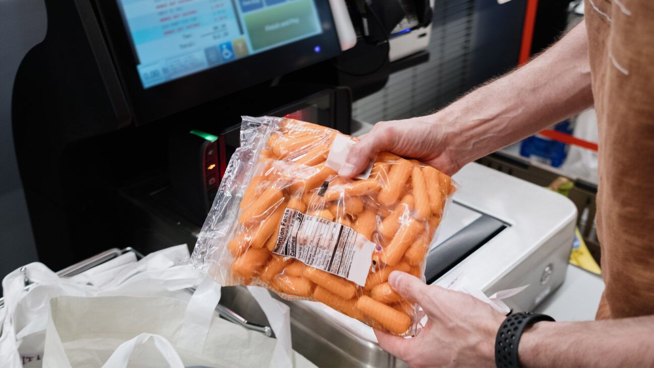 Person buying bagged baby carrots