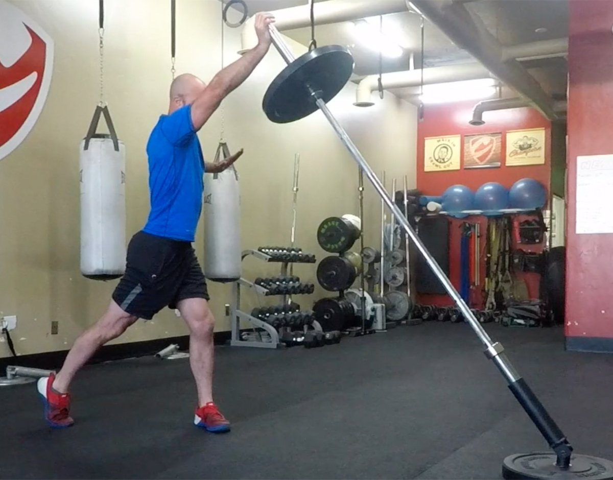 Man performs landmine overhead press