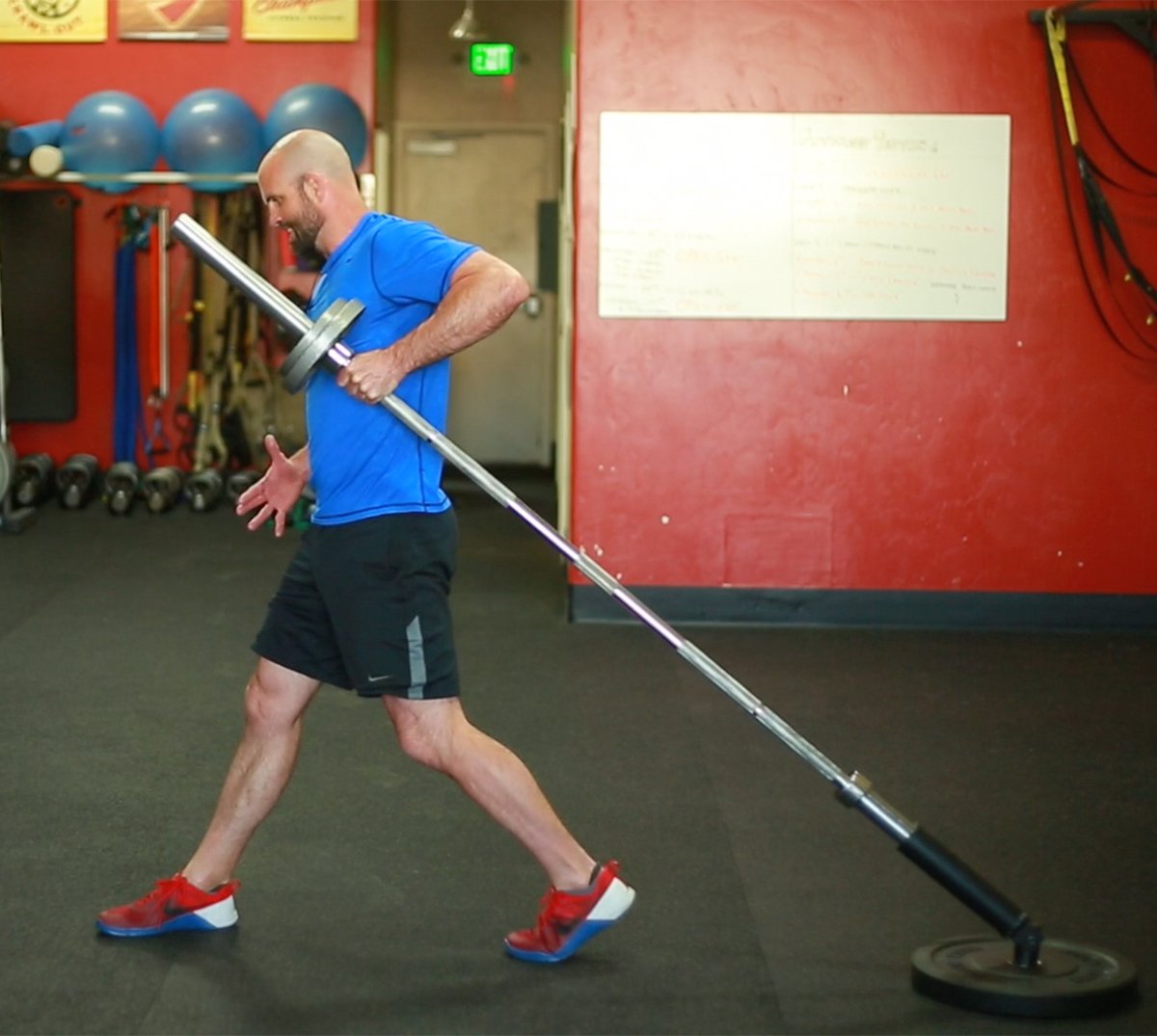 Man performing landmine barbell exercise