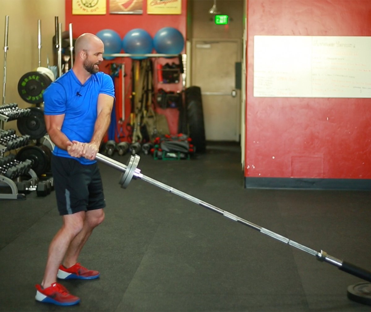 Man performing landmine barbell exercise