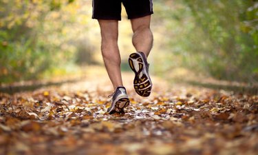 Man jogging on forest trail