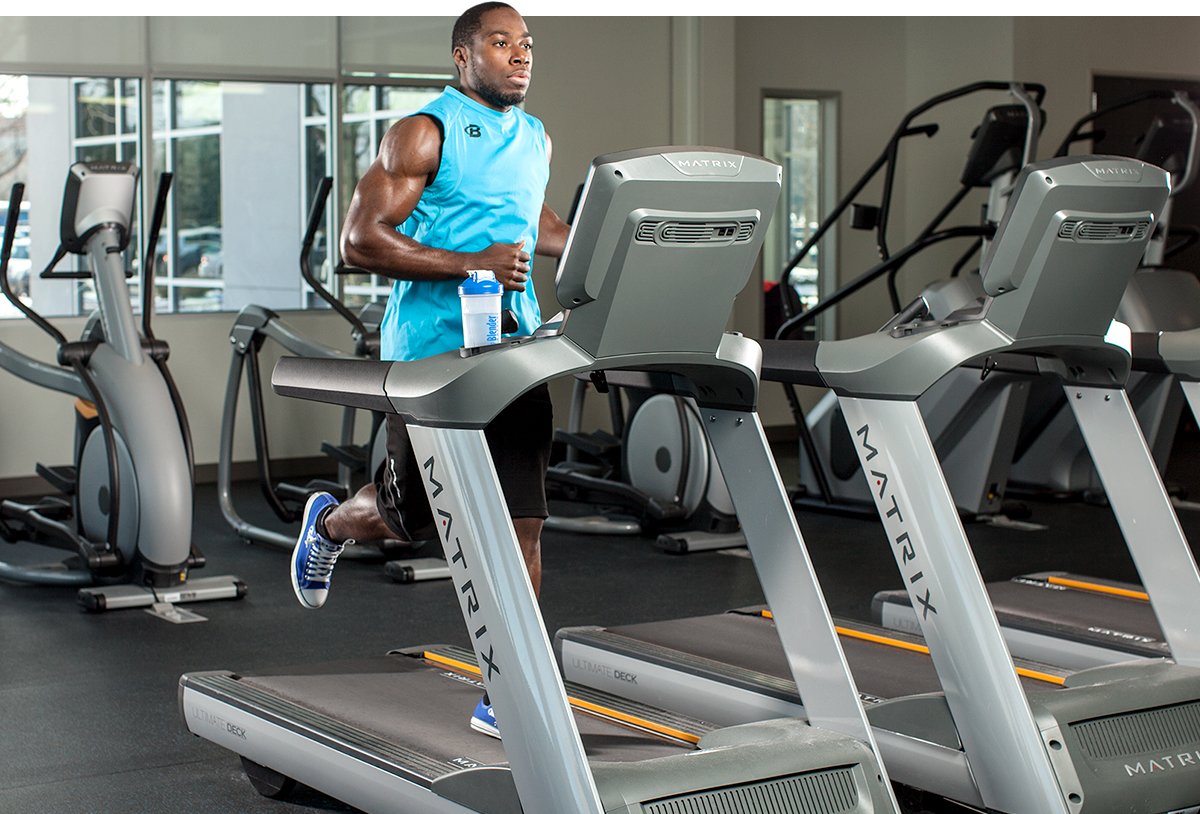 Man exercising on gym treadmill