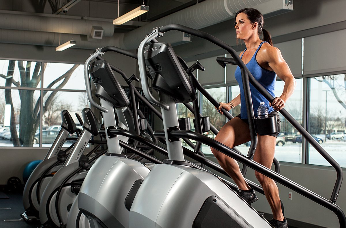 Woman using stairmaster at gym