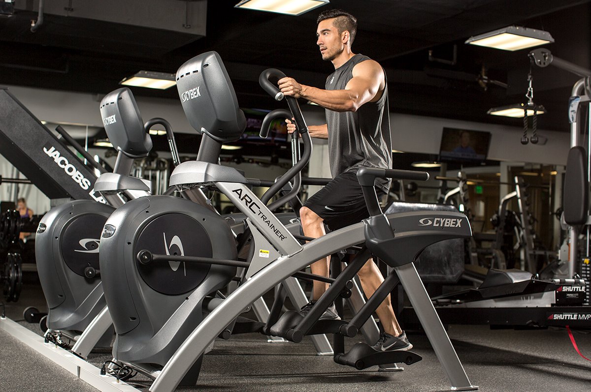 Man exercising on elliptical machine