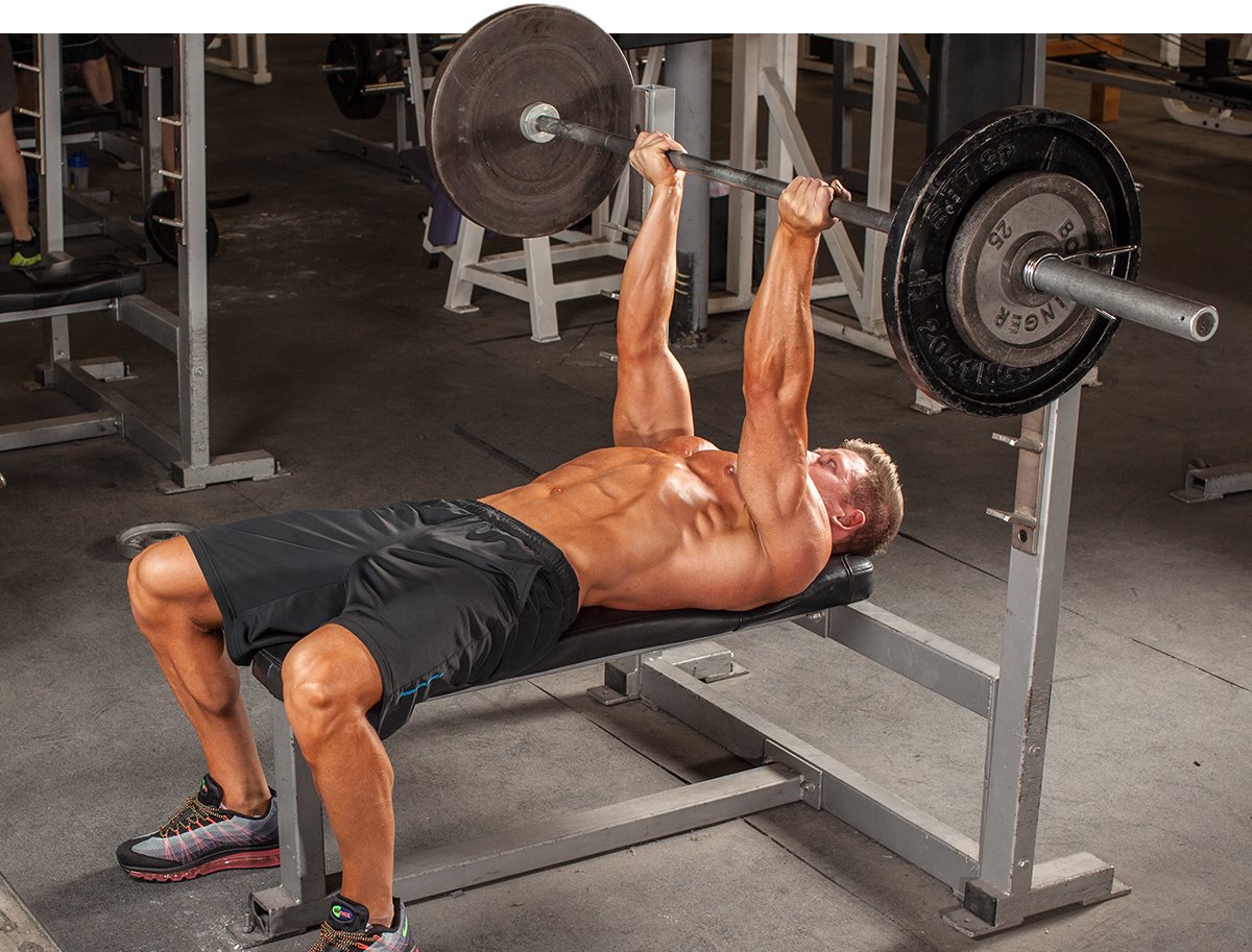 Man bench pressing with barbell