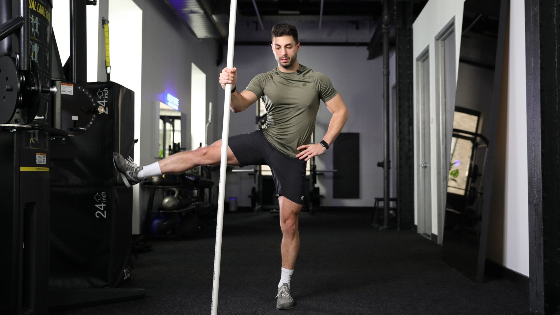 Runner stretching leg on pole