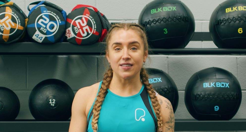 Woman exercising in gym with braids