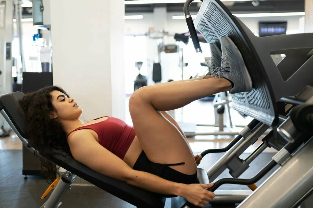 Woman using leg press, foot placement