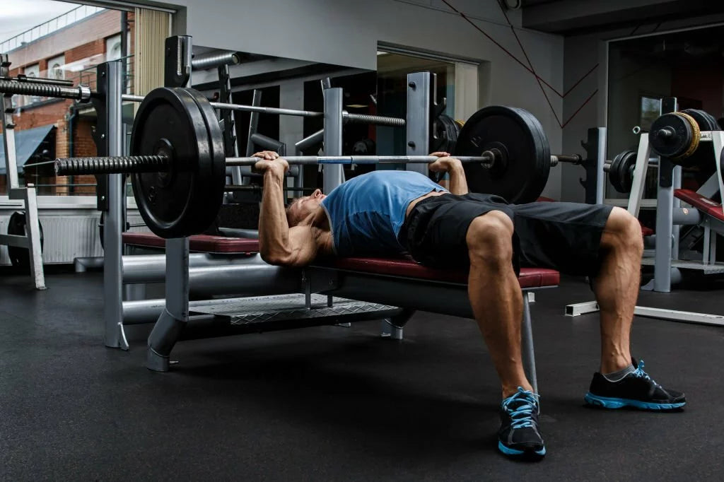 Man performing bench press with dumbbells