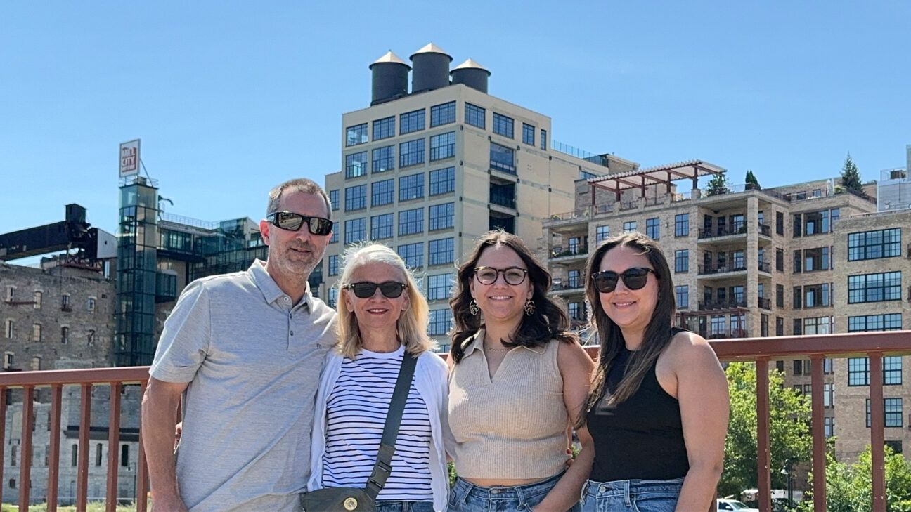 Family of four smiling together