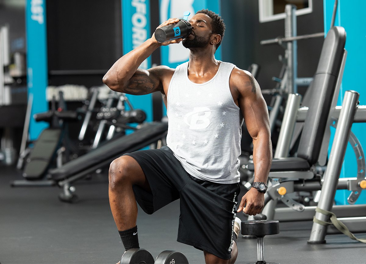 Man drinking creatine shake at gym