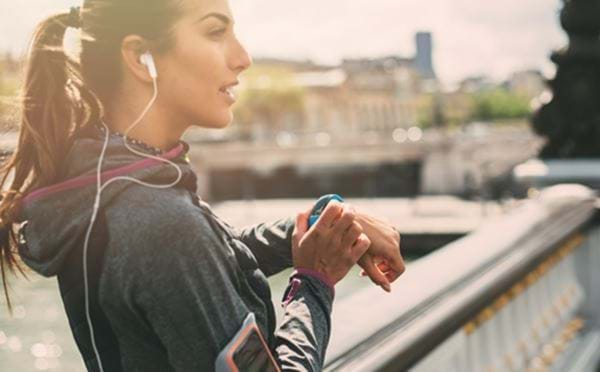 Woman checking smartwatch during workout