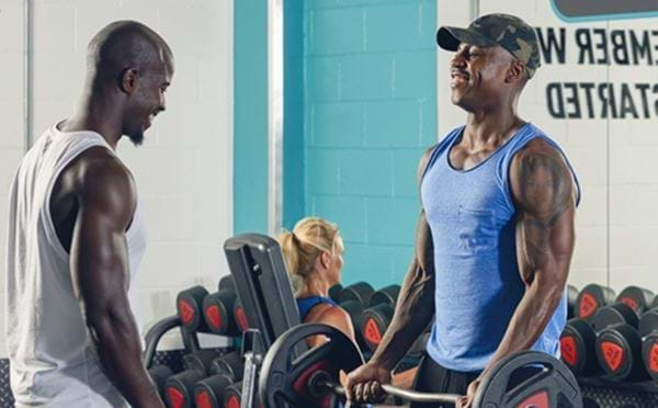 Two men weightlifting in gym