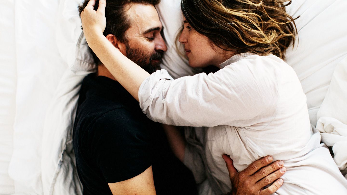 Couple embracing in bed