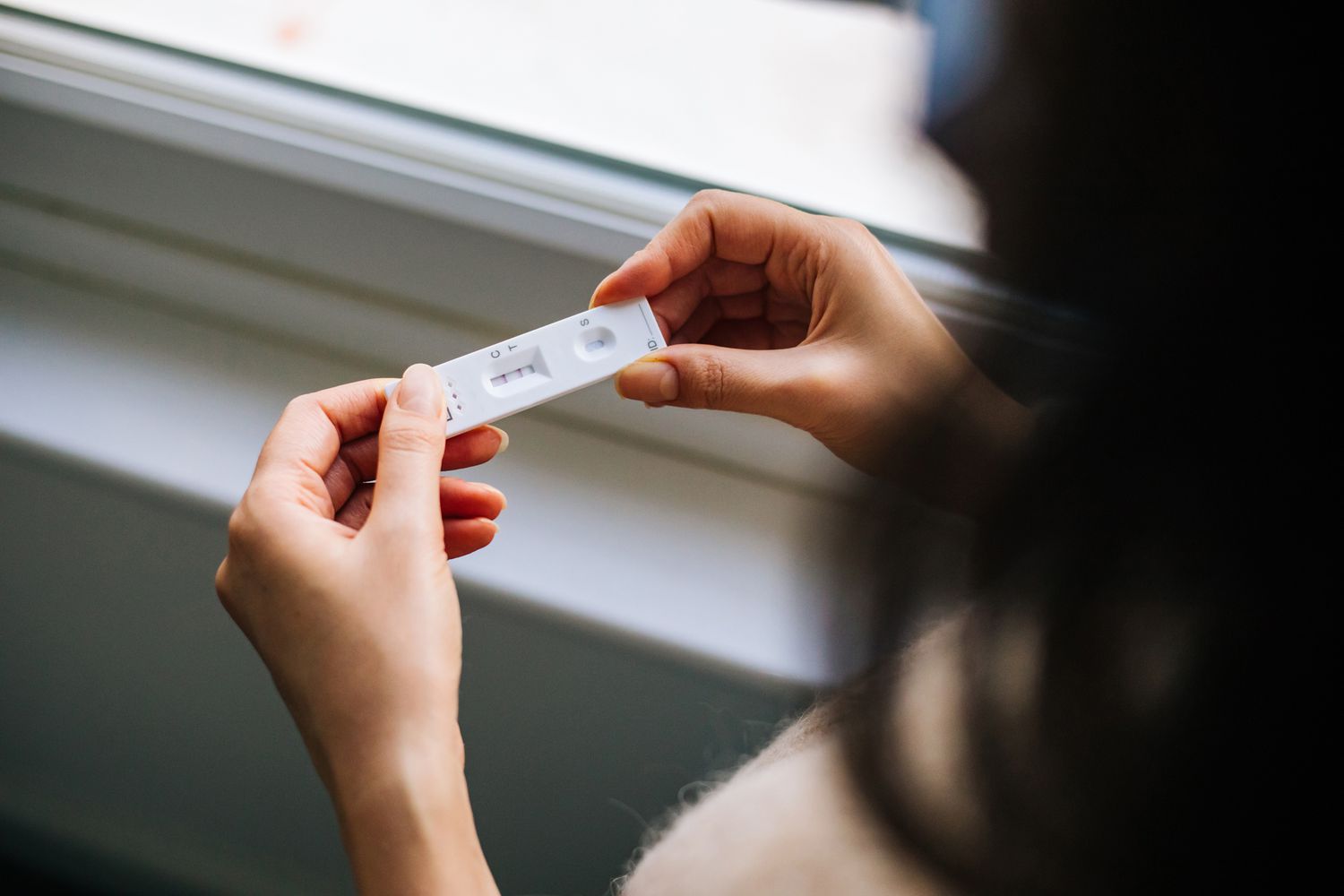 Person examining at-home COVID test