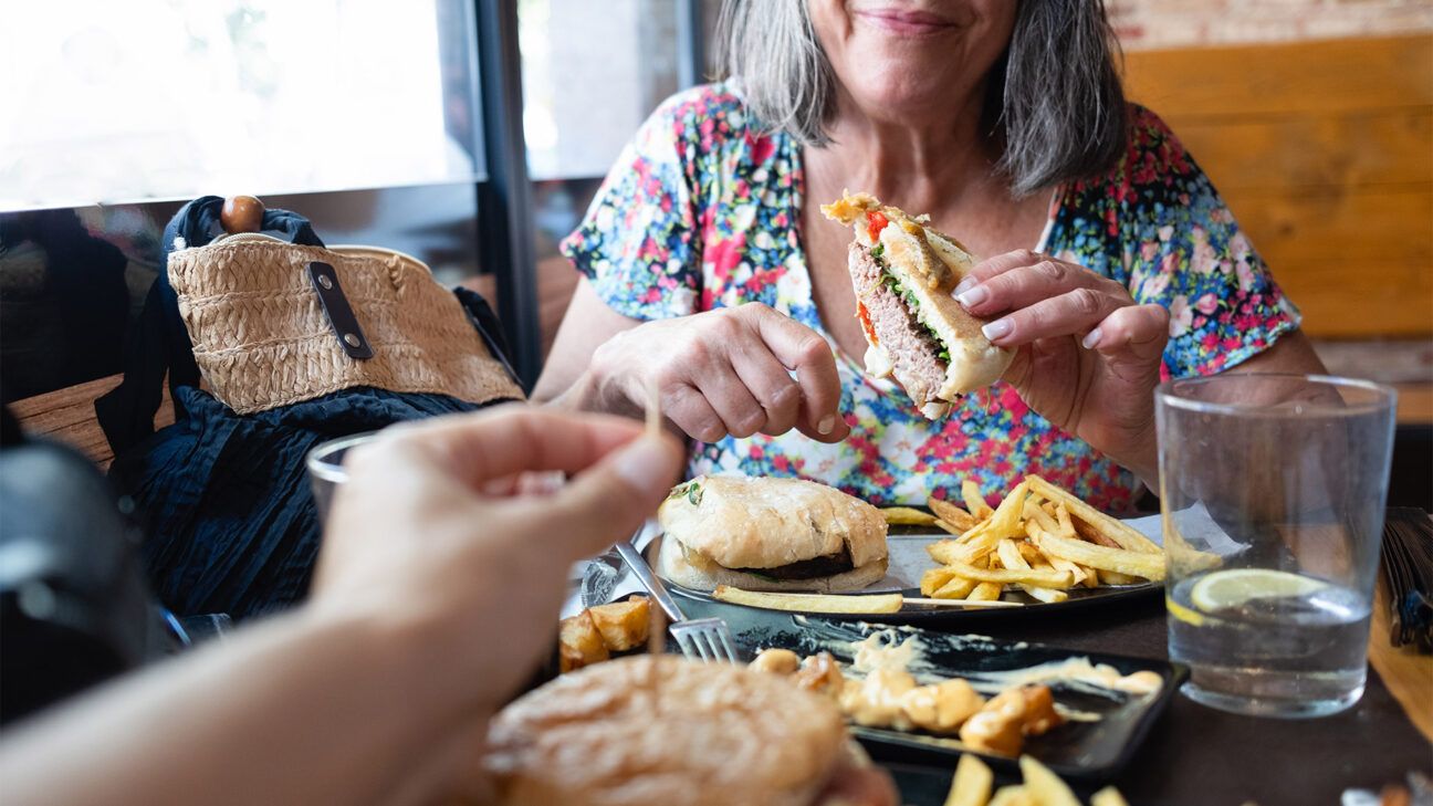 Person eating burger close up