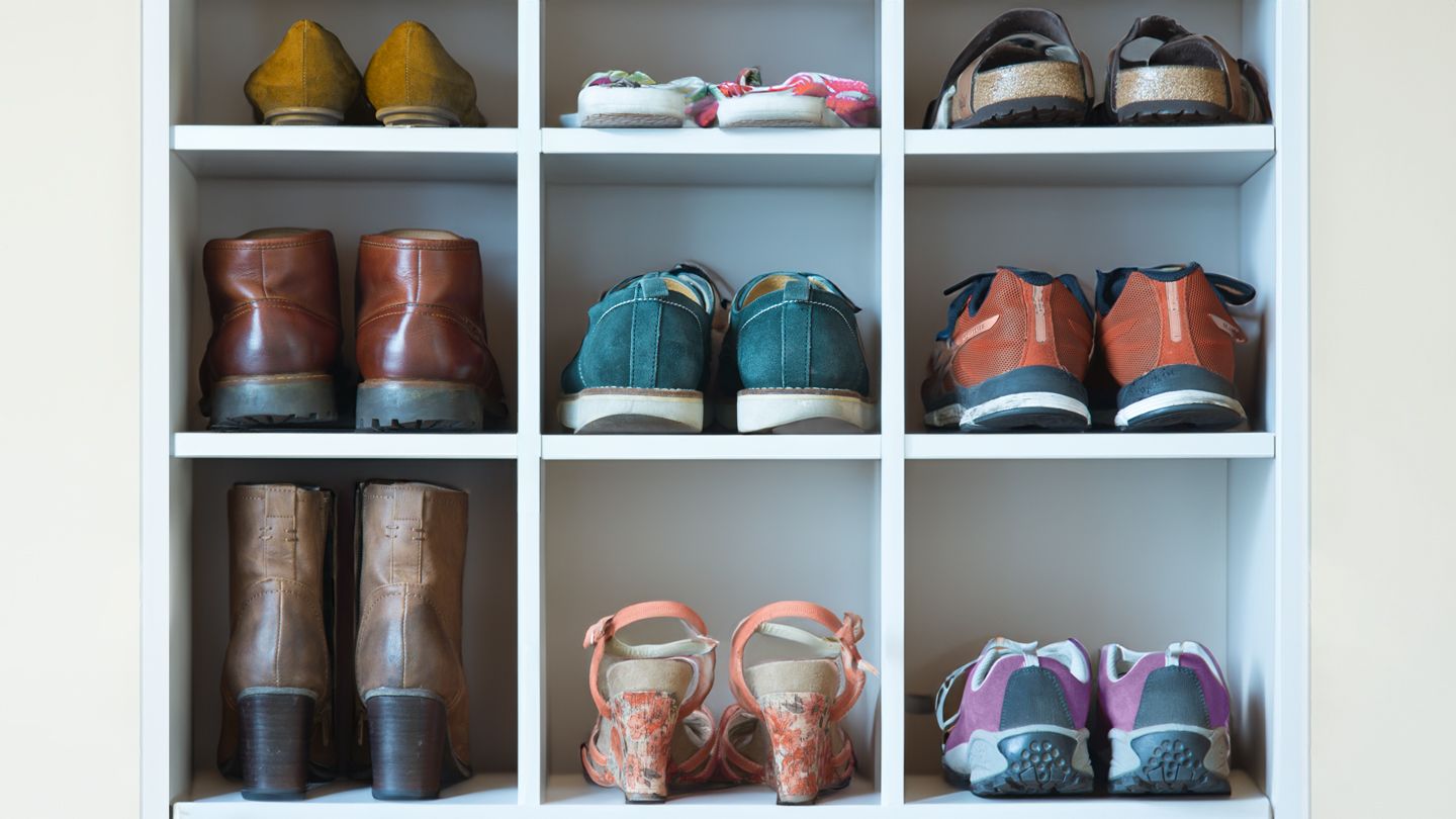 Various shoes displayed on wooden shelves